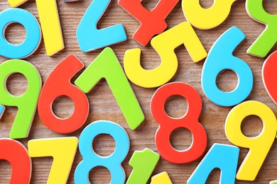 Colorful numbers on wooden table, flat lay