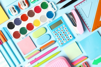Photo of Flat lay composition with different school stationery on light blue background. Back to school