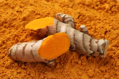 Cut raw root on aromatic turmeric powder, closeup