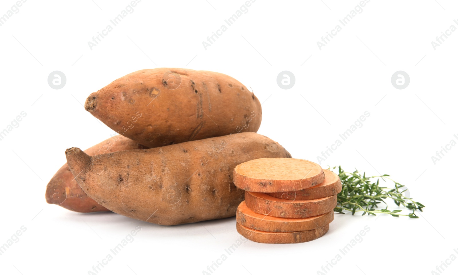 Photo of Cut and whole sweet potatoes with thyme on white background