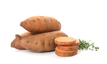 Cut and whole sweet potatoes with thyme on white background