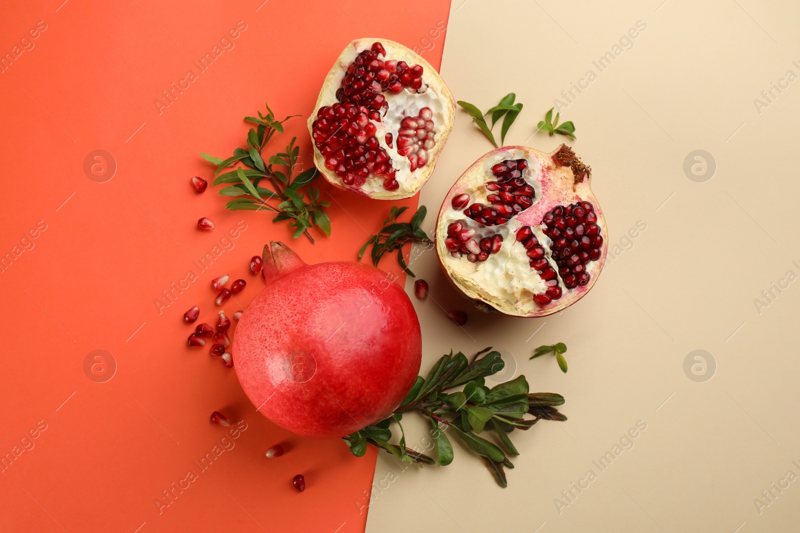 Photo of Flat lay composition with ripe pomegranates on color background
