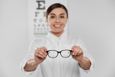 Female ophthalmologist with eyeglasses in clinic, closeup