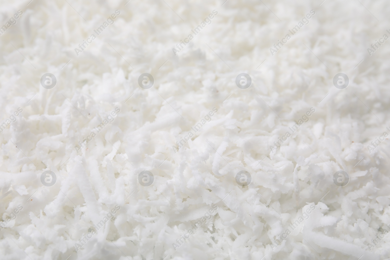 Photo of Fresh coconut flakes as background, closeup view