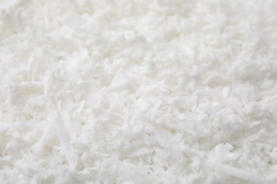 Fresh coconut flakes as background, closeup view