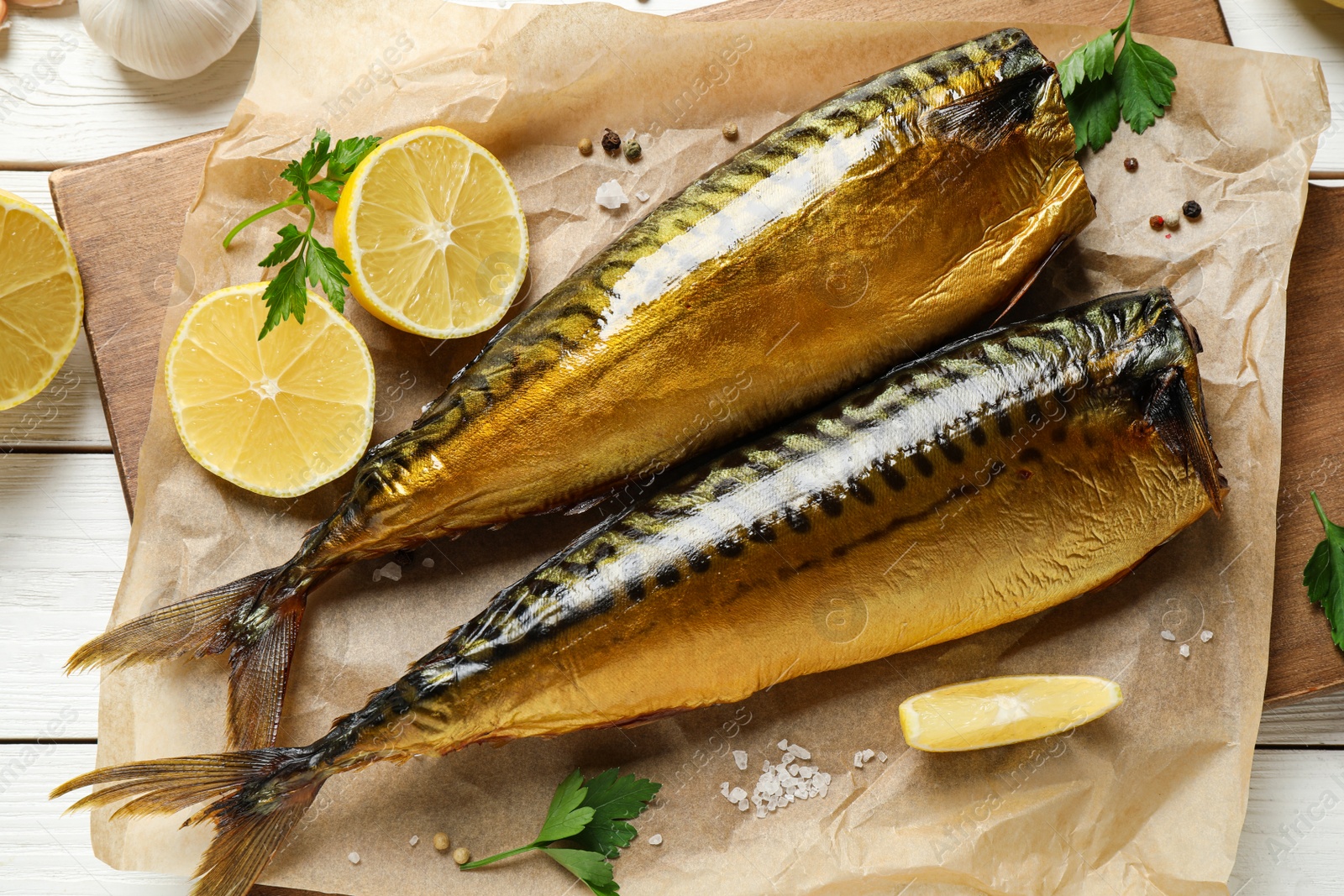 Photo of Flat lay composition with tasty smoked fish on white wooden table