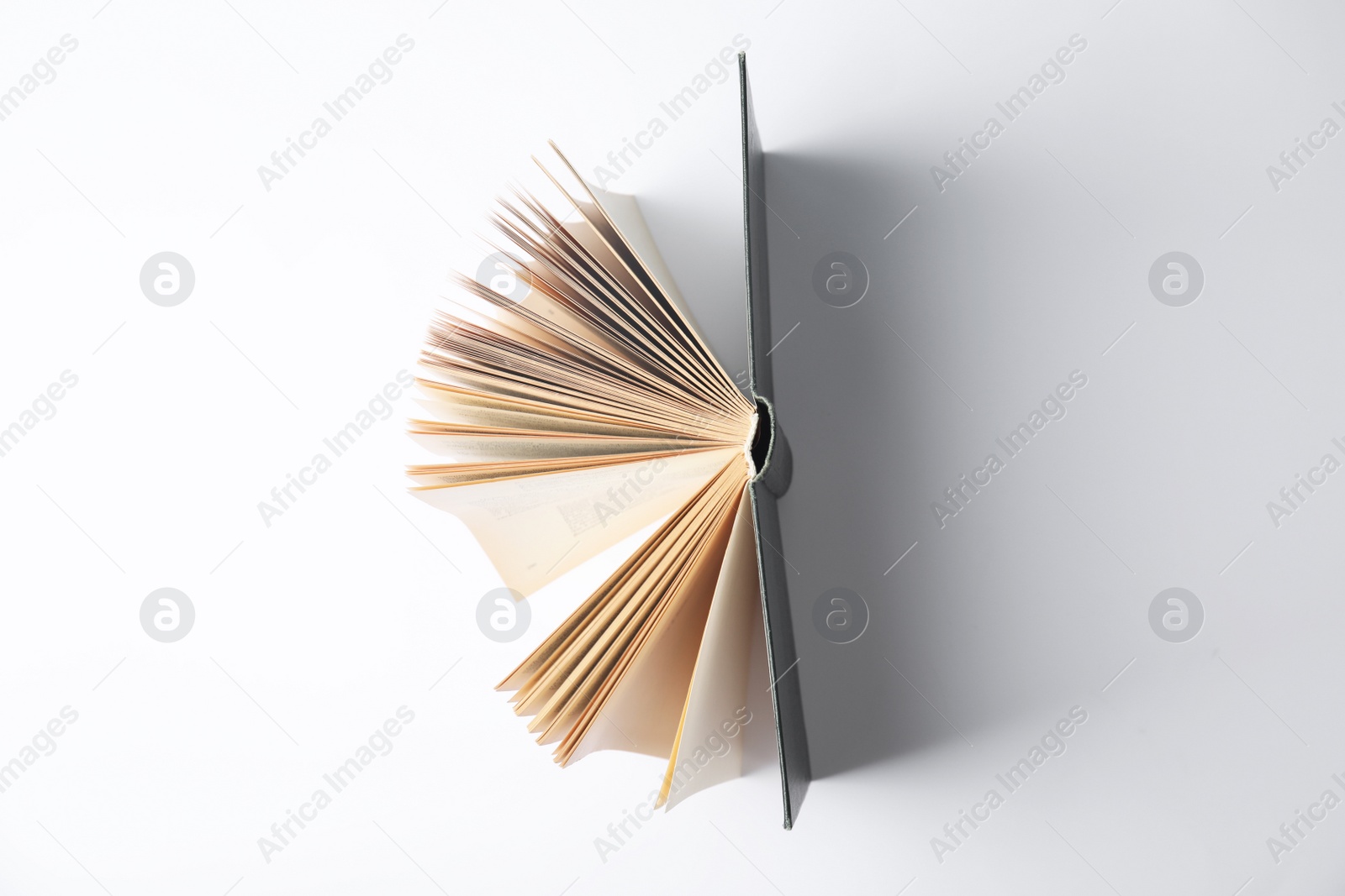 Photo of Open book on white background, top view