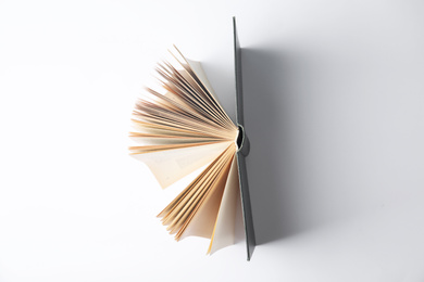 Photo of Open book on white background, top view