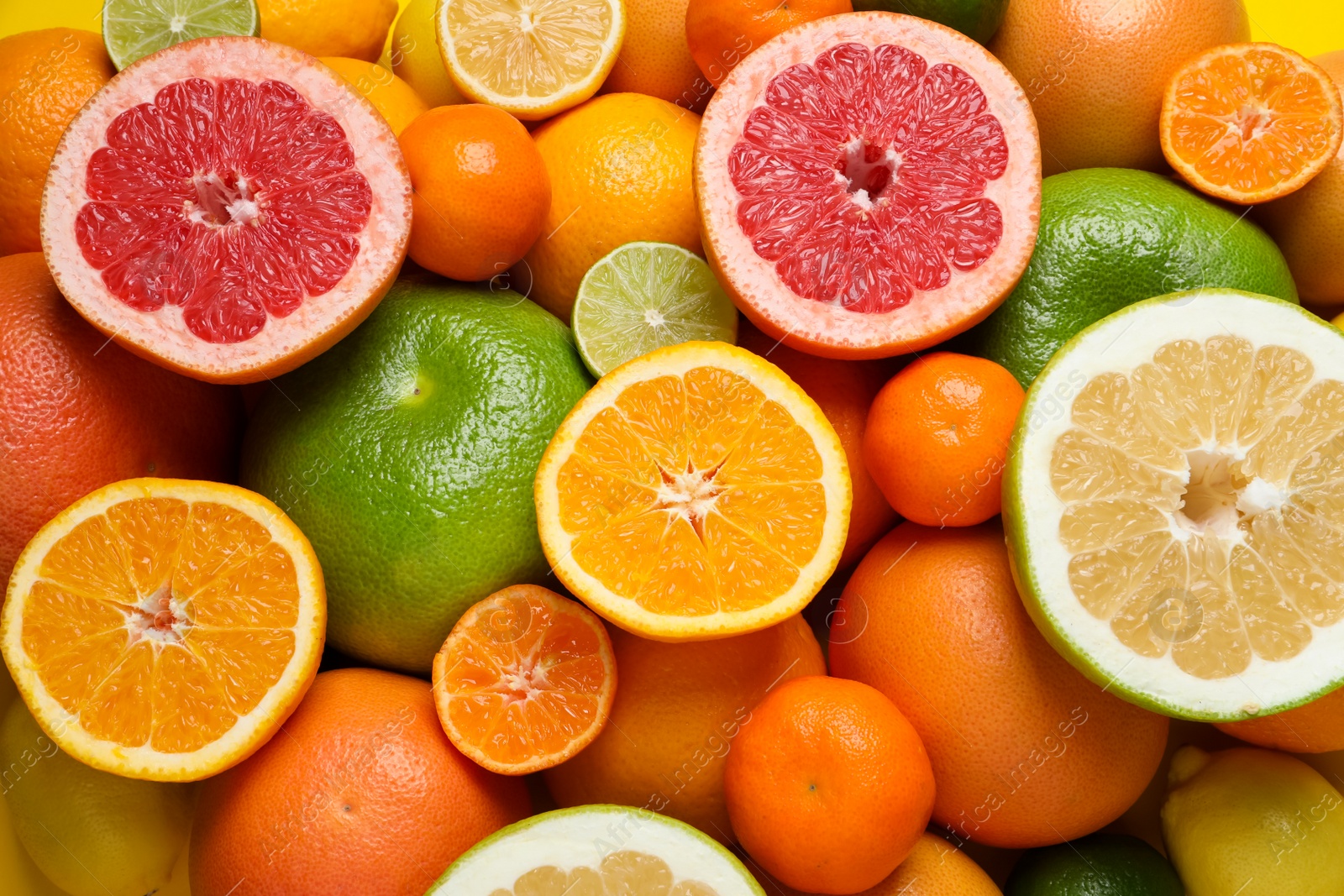 Photo of Different ripe citrus fruits as background, top view