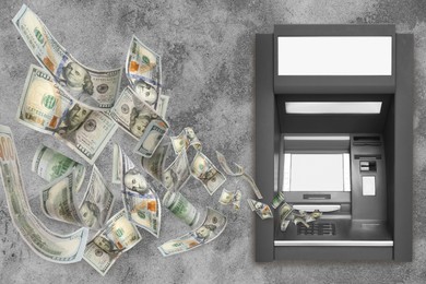 Image of Modern automated cash machine and flying money on grey stone background