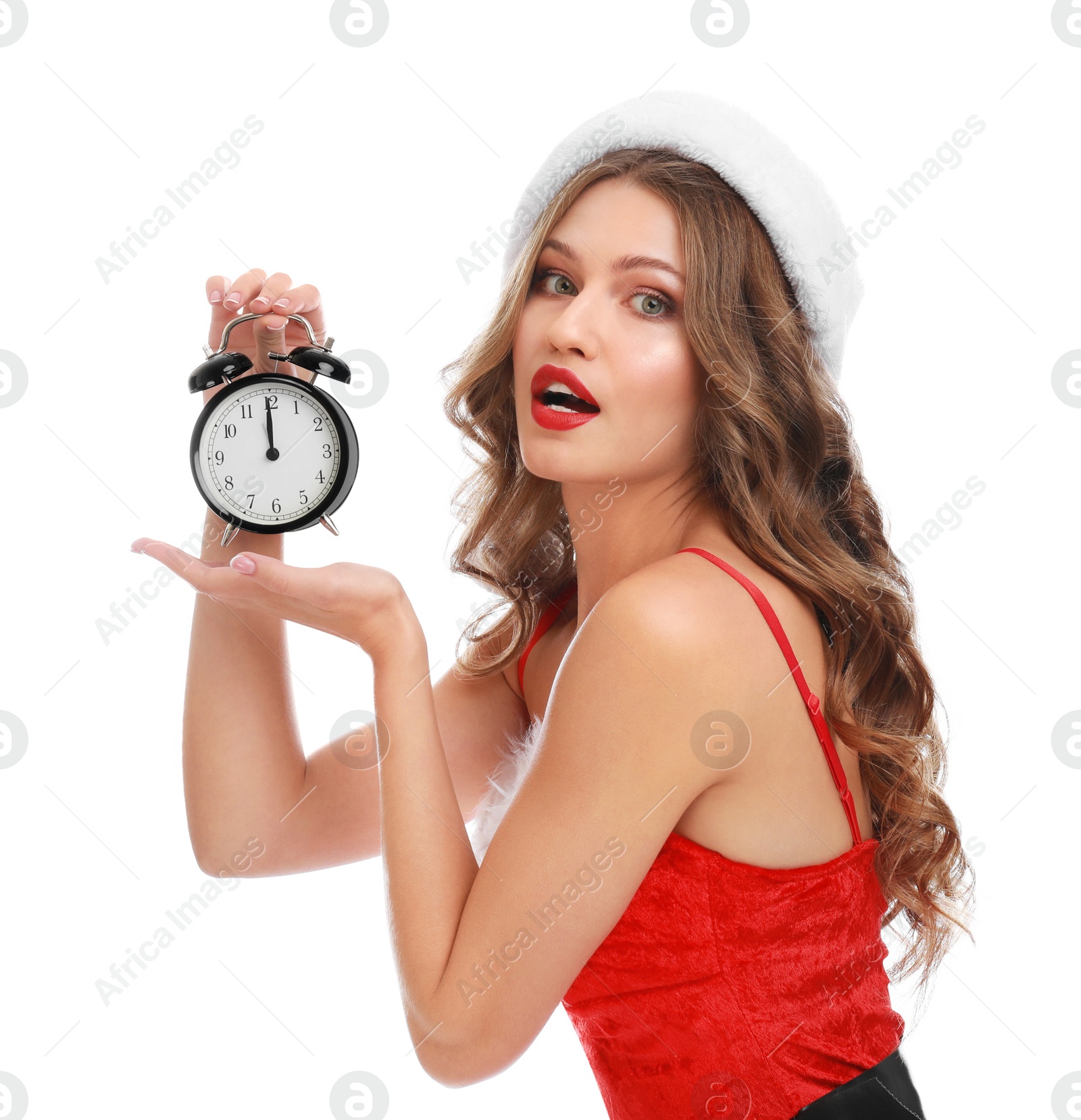 Photo of Beautiful Santa girl with alarm clock on white background. Christmas celebration