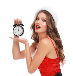 Beautiful Santa girl with alarm clock on white background. Christmas celebration