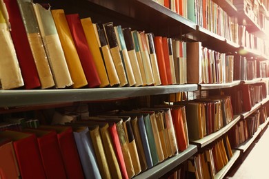 Image of Collection of different books on shelves in library