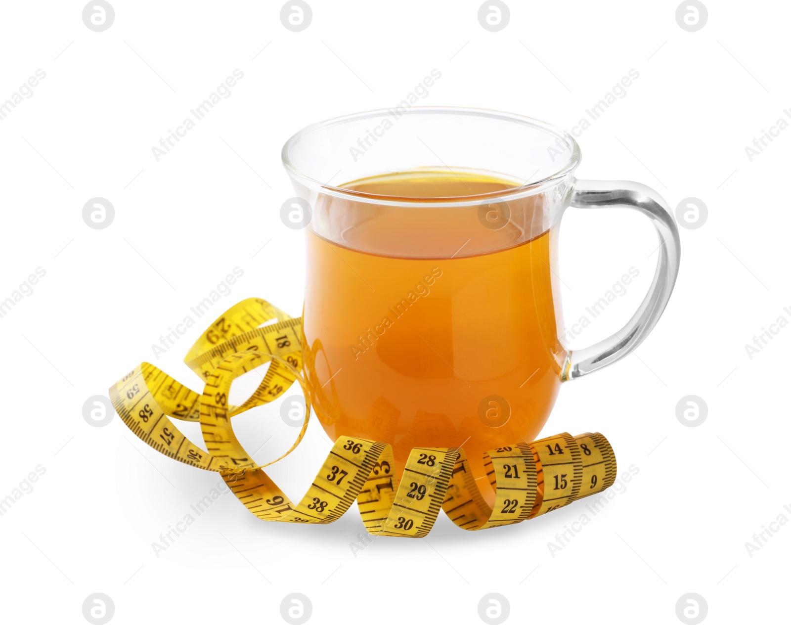 Photo of Glass cup of diet herbal tea and measuring tape on white background. Weight loss