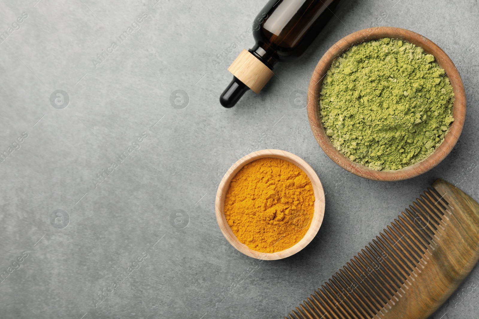 Photo of Flat lay composition with henna and turmeric powder on light grey table, space for text. Natural hair coloring