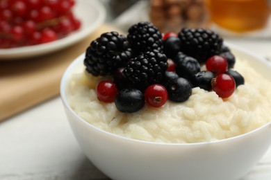 Delicious rice pudding with berries, closeup view