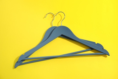 Photo of Flat lay composition with empty hangers on color background