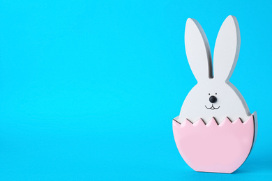 Bunny figure as Easter decor on blue background. Space for text