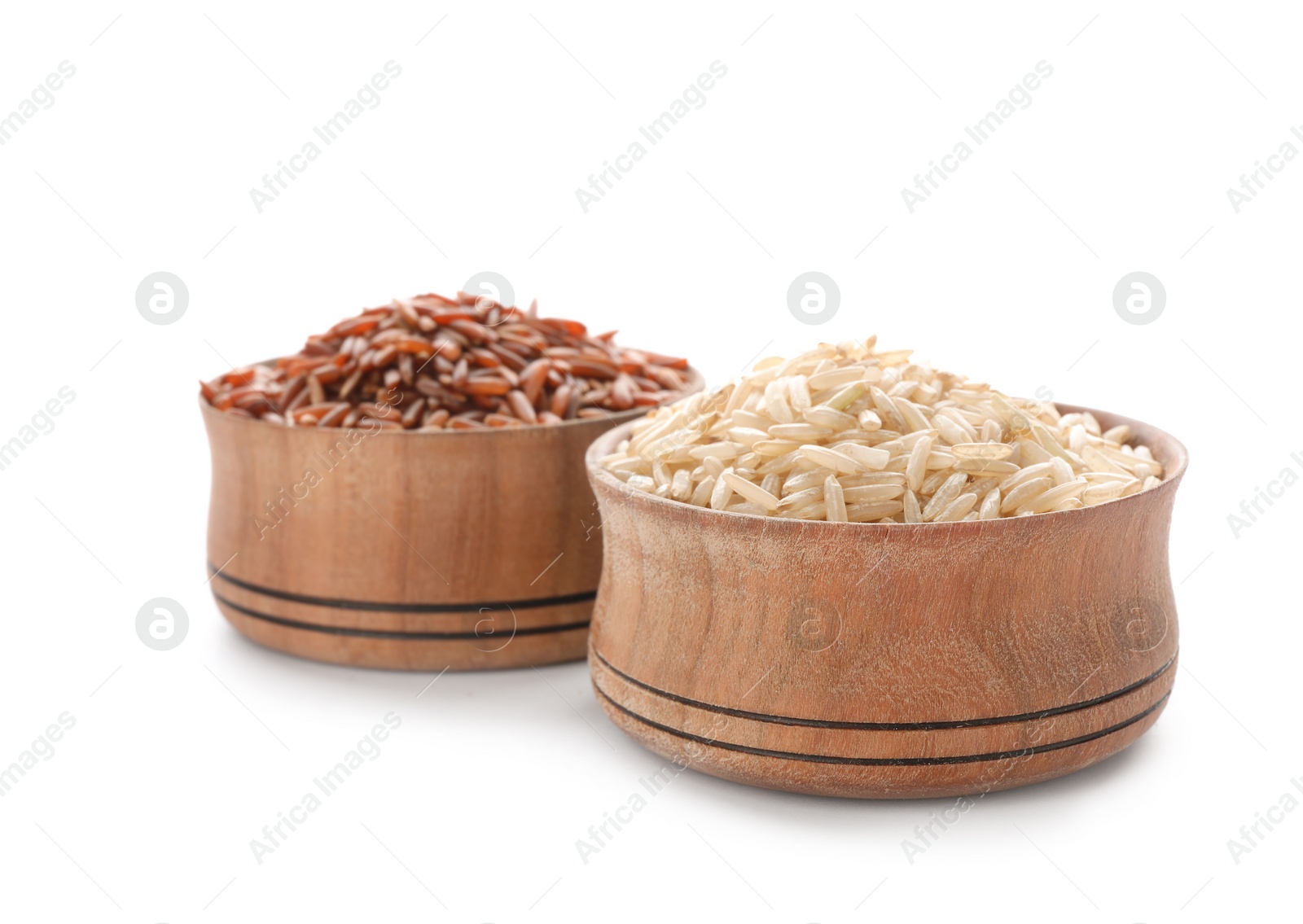 Photo of Wooden bowls with brown rice on white background