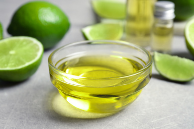 Photo of Lime essential oil in bowl on light table