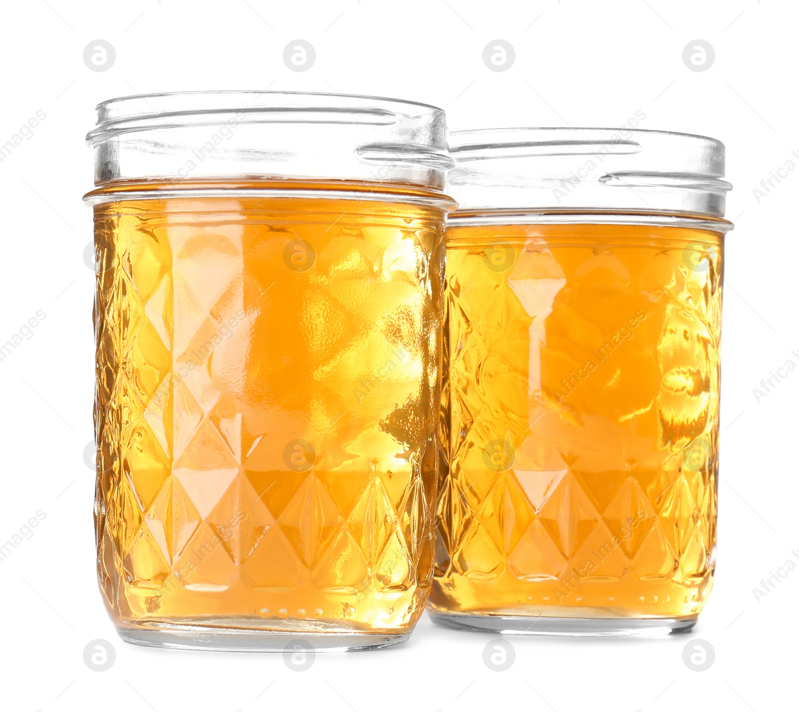 Photo of Two jars of fresh apple juice on white background