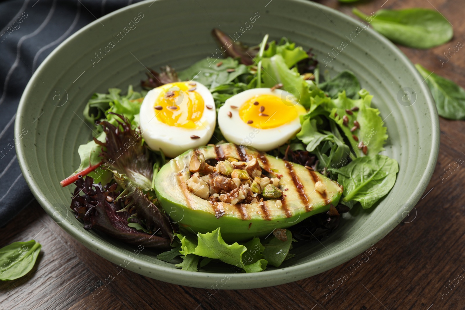 Photo of Healthy dish high in vegetable fats on wooden table, closeup