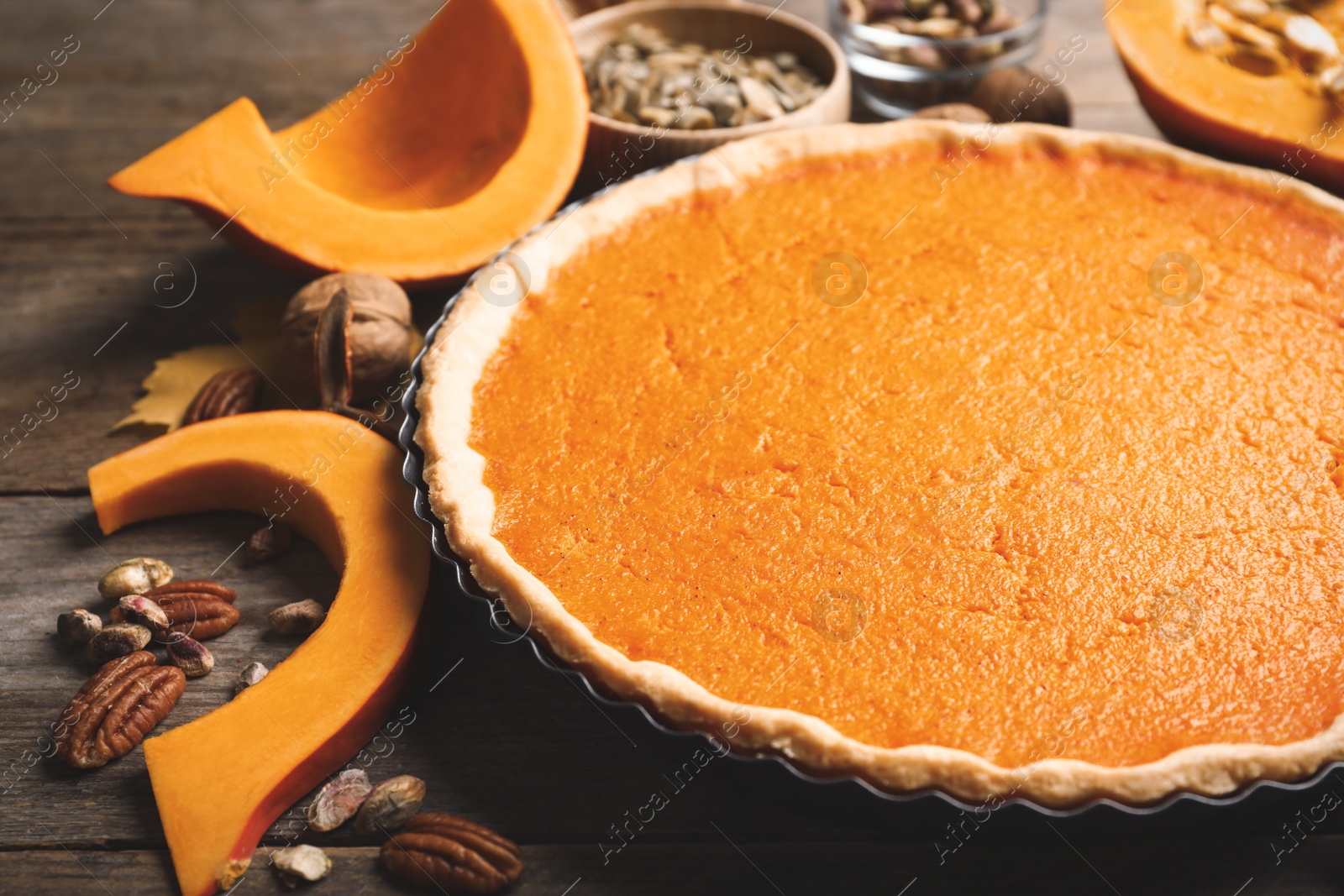 Photo of Delicious homemade pumpkin pie on wooden table, closeup