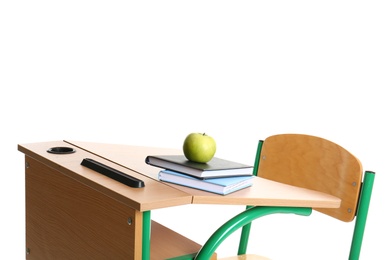 Wooden school desk with stationery and apple on white background