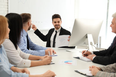 Photo of Professional business trainer working with people in office