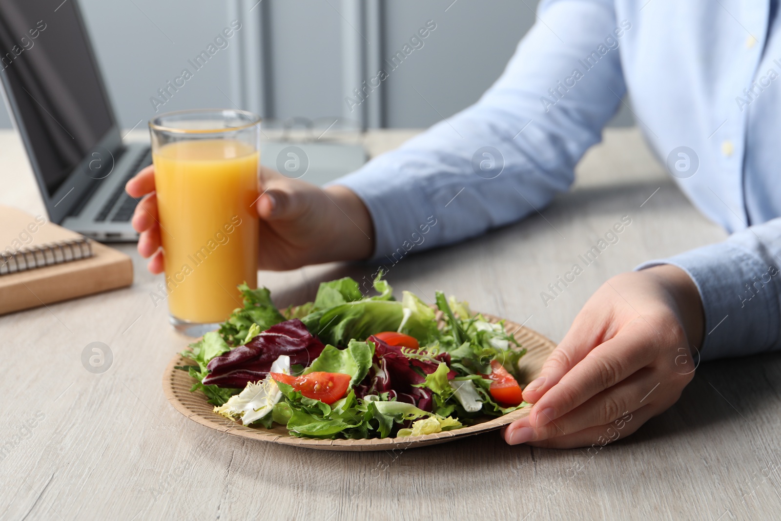 Photo of Office employee having business lunch at workplace, closeup