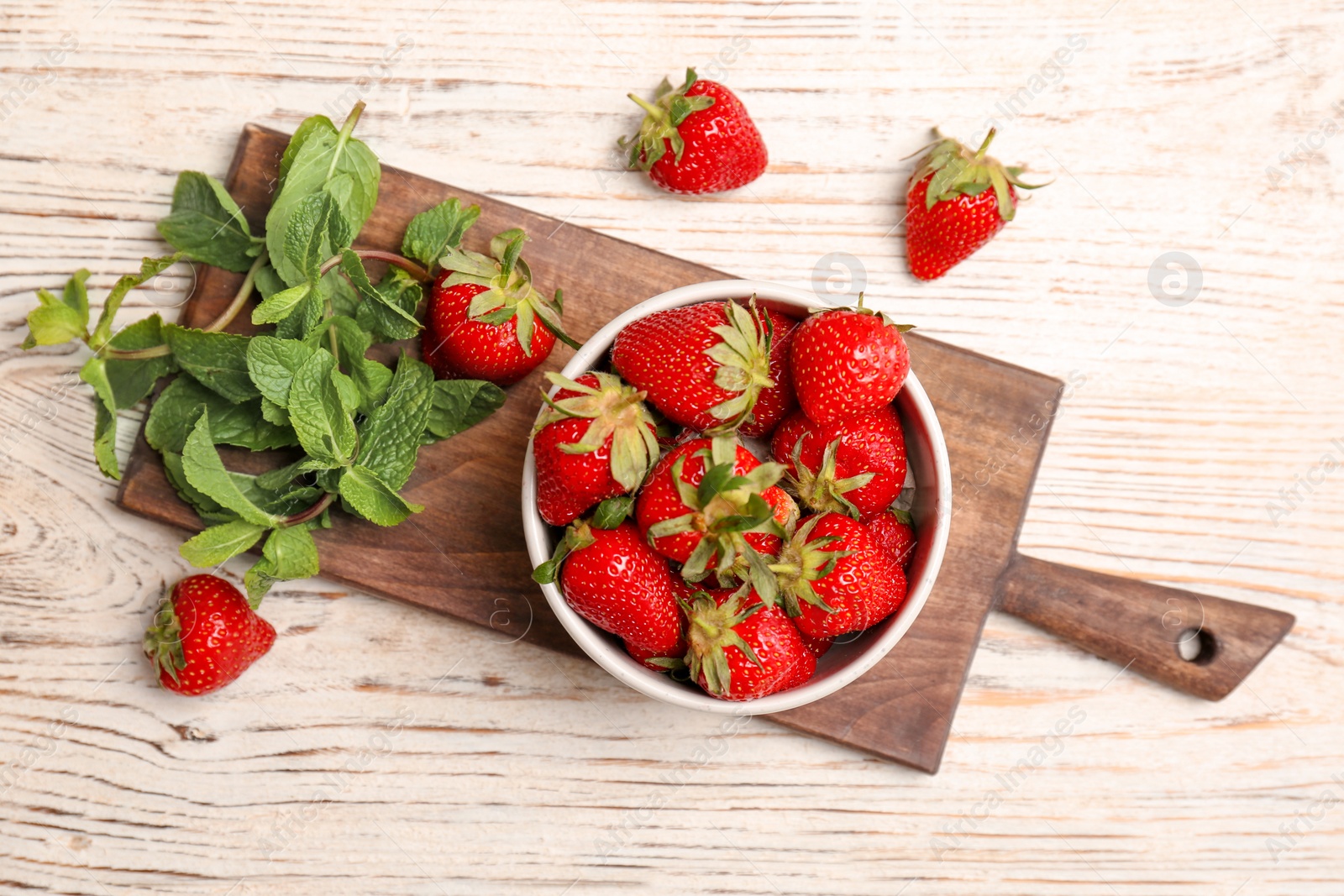 Photo of Flat lay composition with ripe red strawberries and mint on wooden background