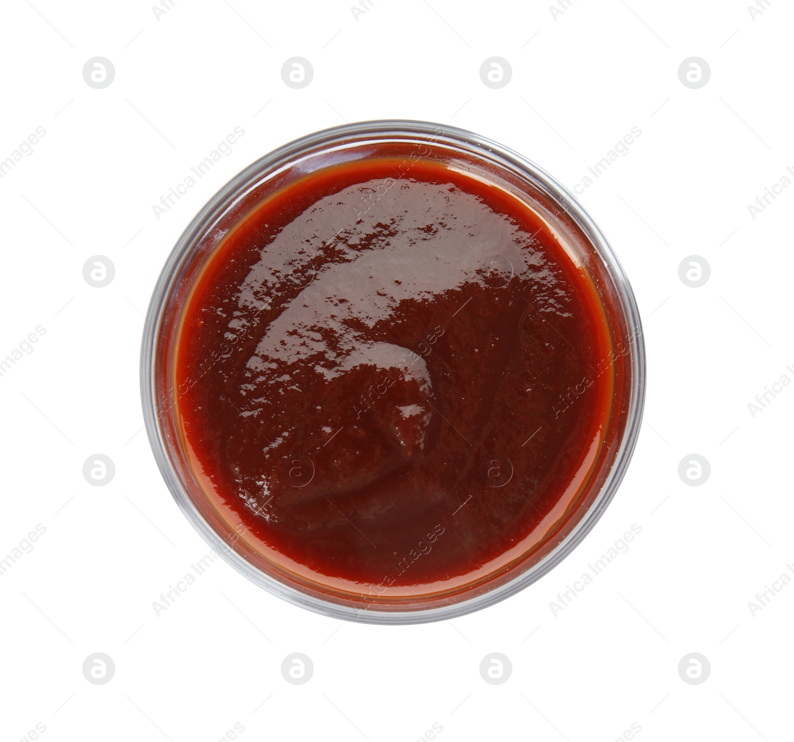 Photo of Glass bowl of barbecue sauce on white background, top view