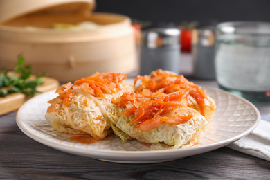 Photo of Delicious cabbage rolls on wooden table, closeup