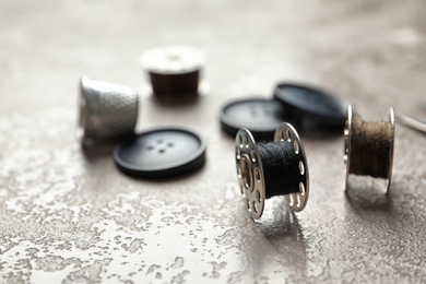 Photo of Set of tailoring accessories on grey background