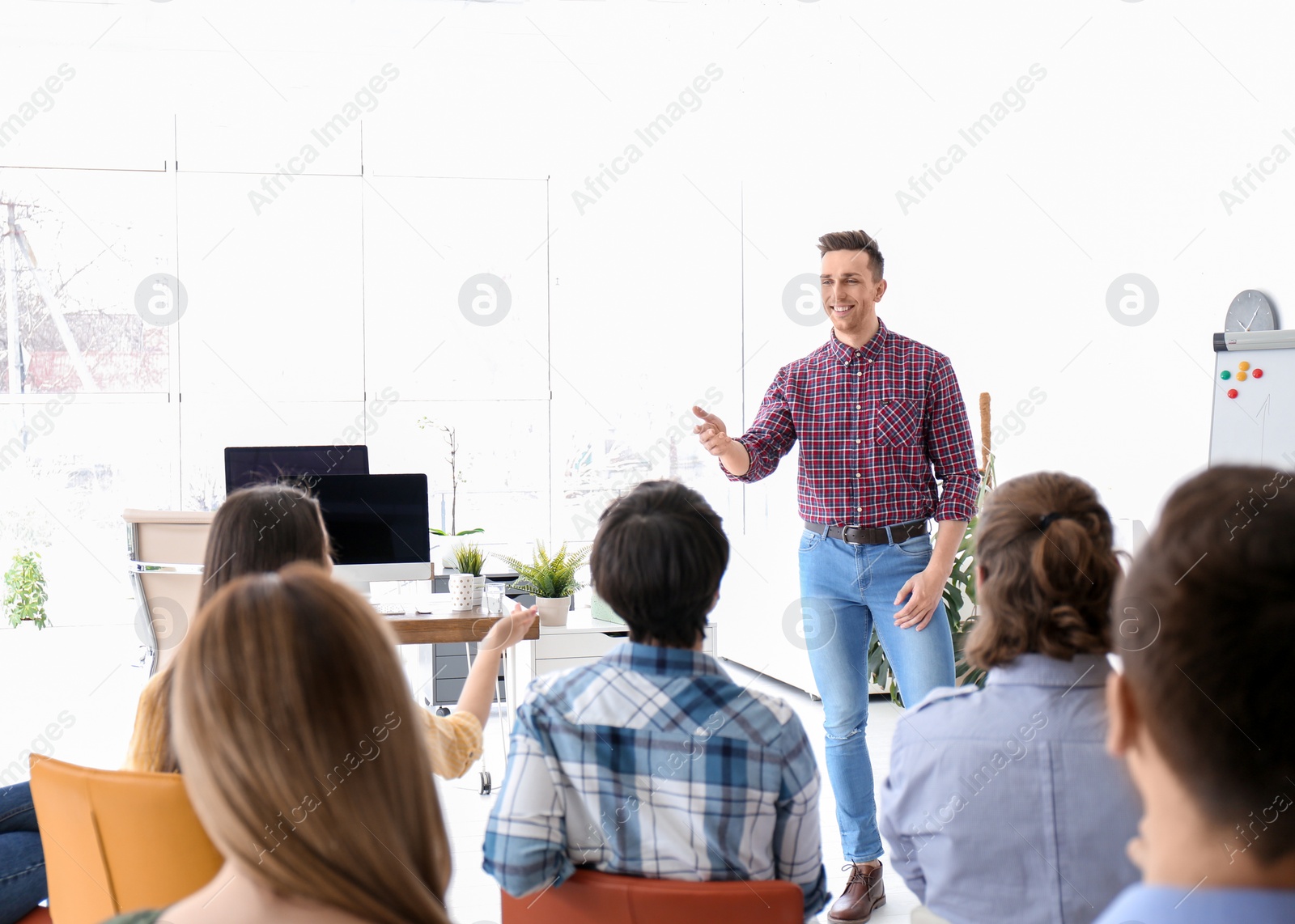 Photo of Male business trainer giving lecture in office