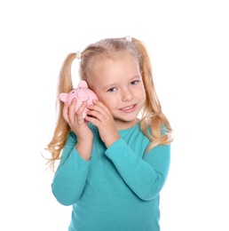 Little girl with piggy bank on white background