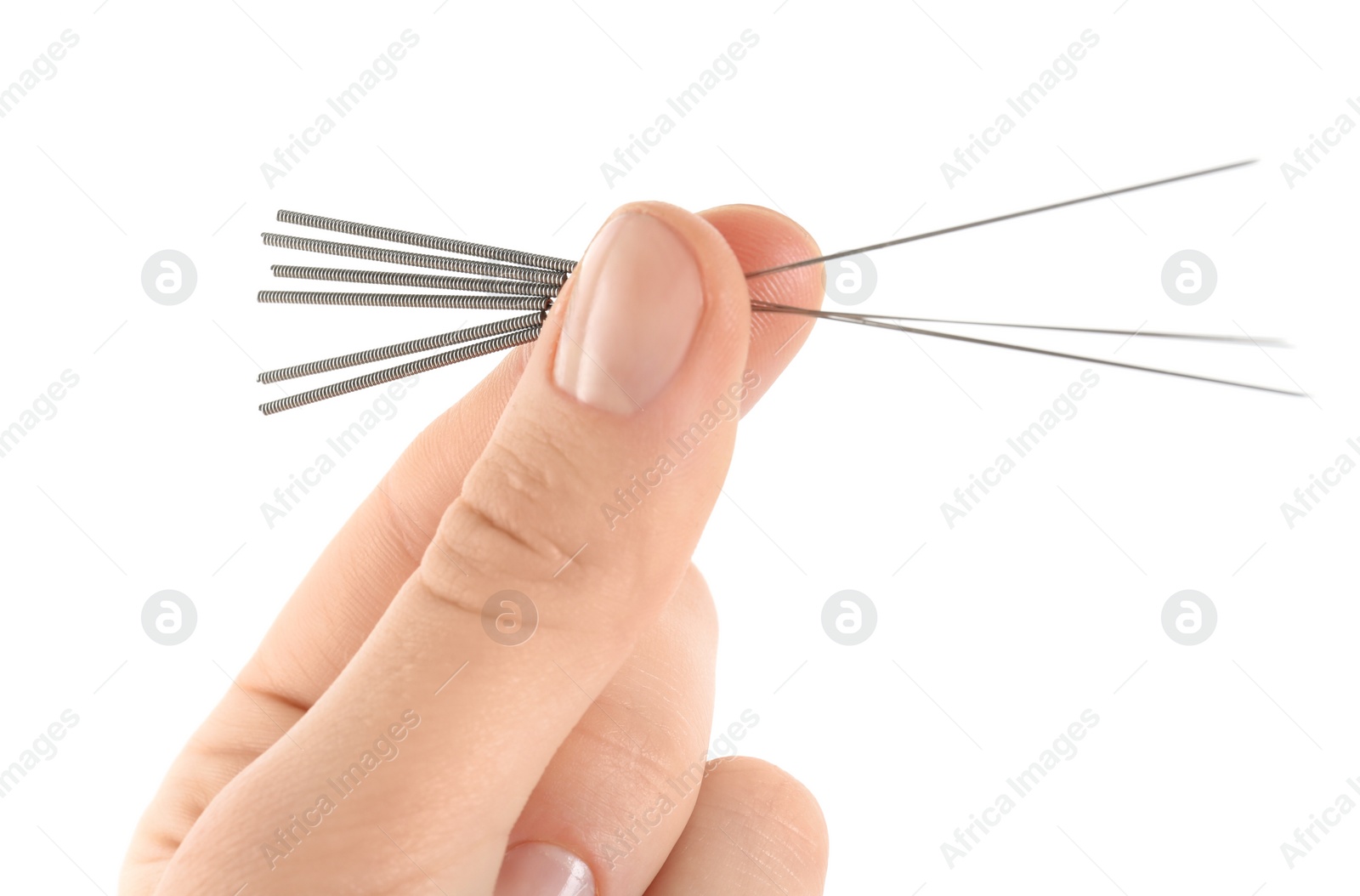 Photo of Woman holding needles for acupuncture on white background, closeup