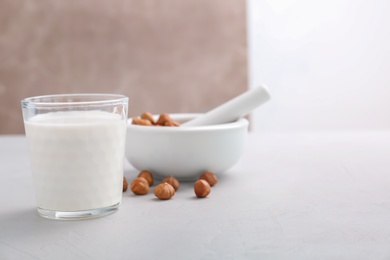 Glass with hazelnut milk on table