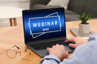 Image of Webinar. Man using laptop at table, closeup