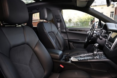 Photo of Inside of modern black car with leather seats