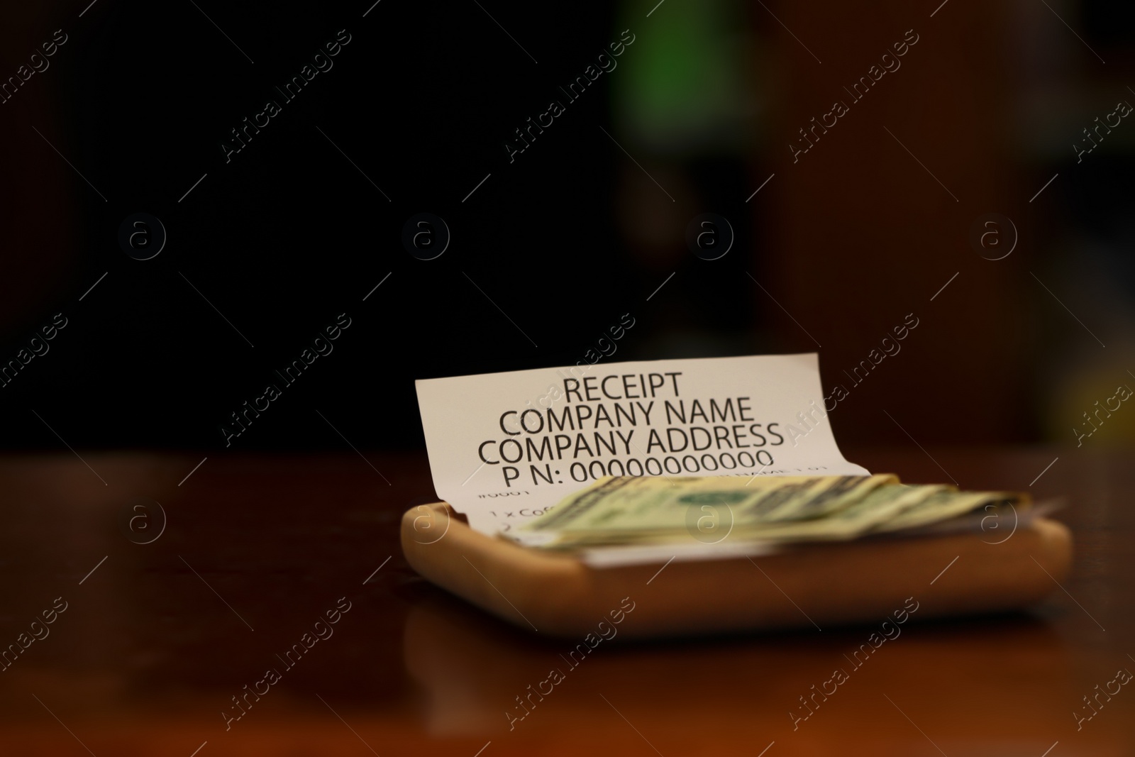 Photo of Tips and receipt on wooden table, space for text