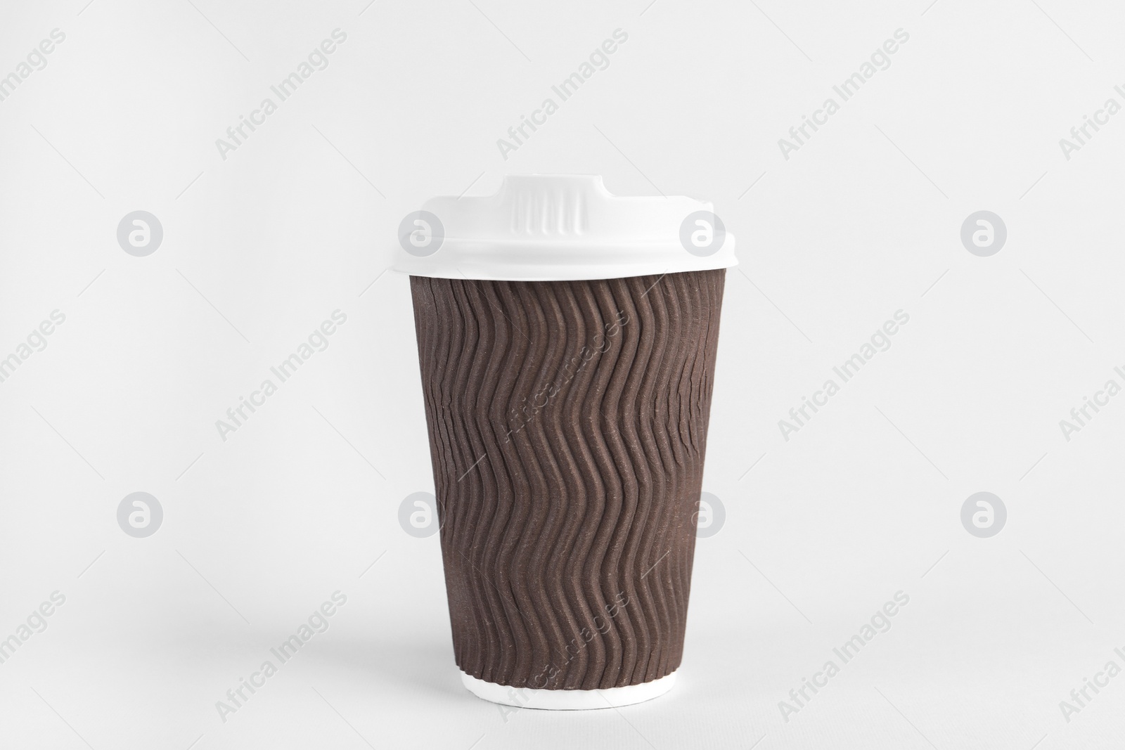 Photo of Brown paper cup with plastic lid on light background. Coffee to go