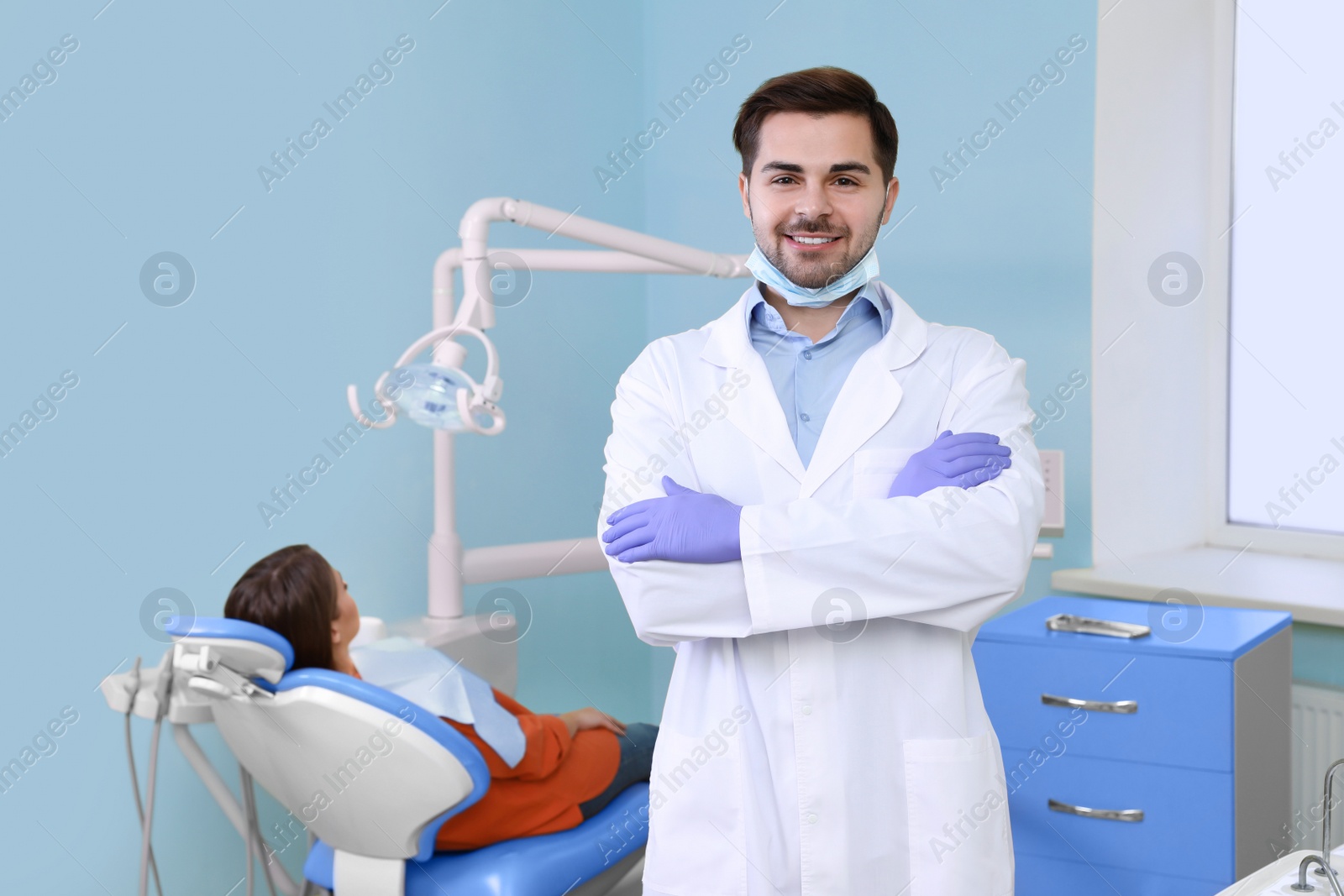 Photo of Professional dentist and patient in modern clinic