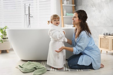 Photo of Mother with her daughter after bath at home