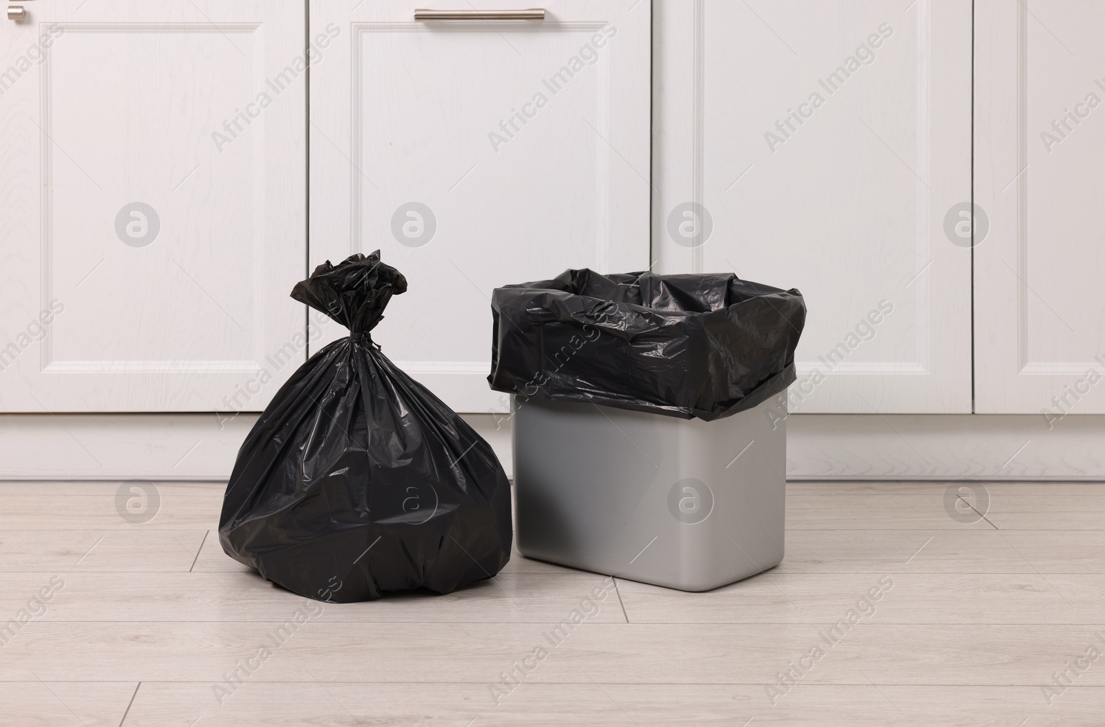 Photo of Plastic garbage bag and trash can indoors