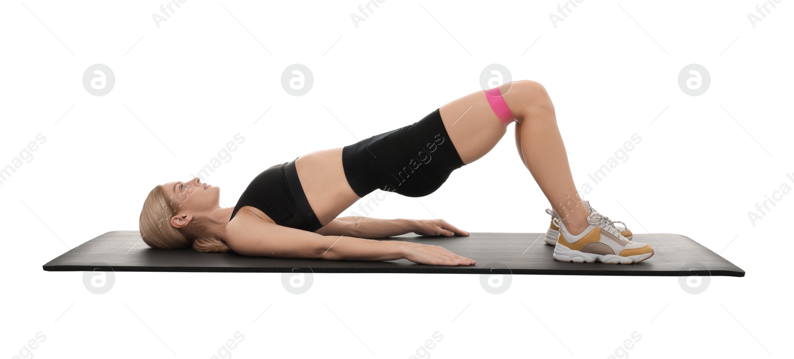 Photo of Woman exercising with elastic resistance band on fitness mat against white background