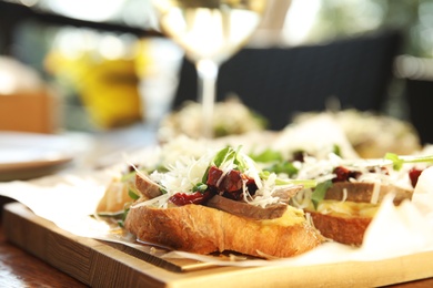 Photo of Delicious bruschettas with beef and cheese on table, closeup