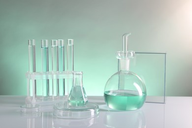 Photo of Laboratory analysis. Different glassware on table against color background