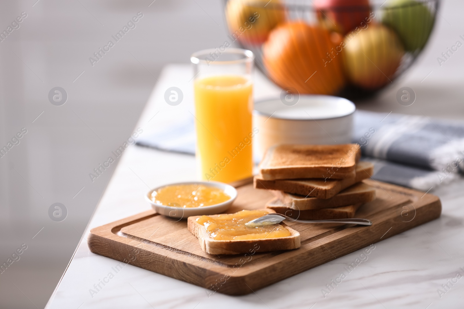 Photo of Delicious breakfast with toasts and jam on table in kitchen