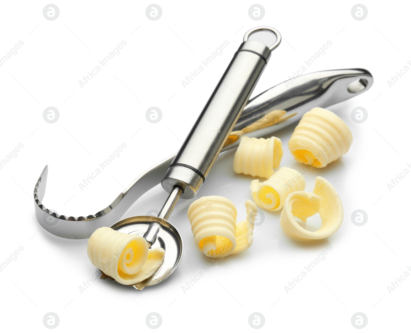 Photo of Utensils with butter curls on white background